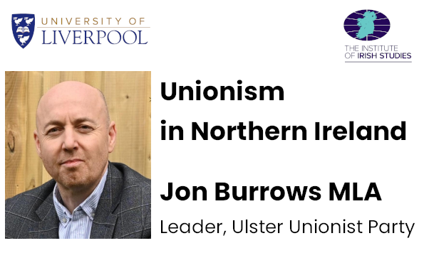 Colour portrait photo of Jon Burrows (white man with shaven head, waring a suit)