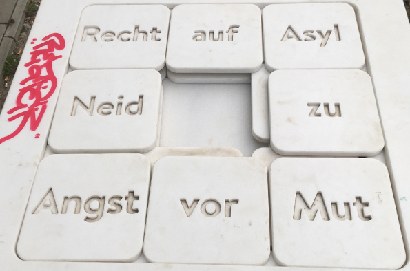 A table with German words on that can be moved to create phrases. The phrases that are made are